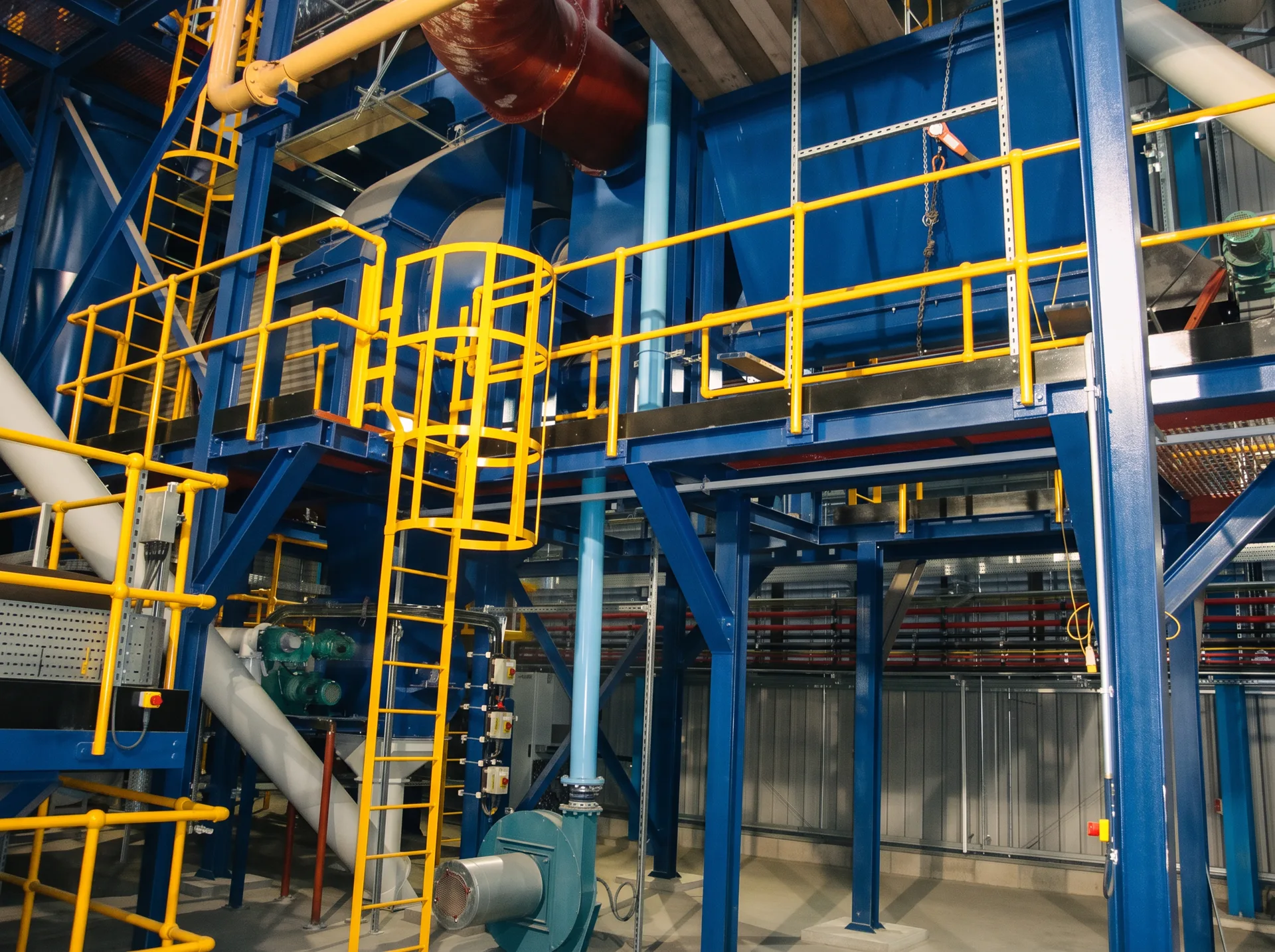 Industrial process plant interior with steelwork, ducts and access platforms